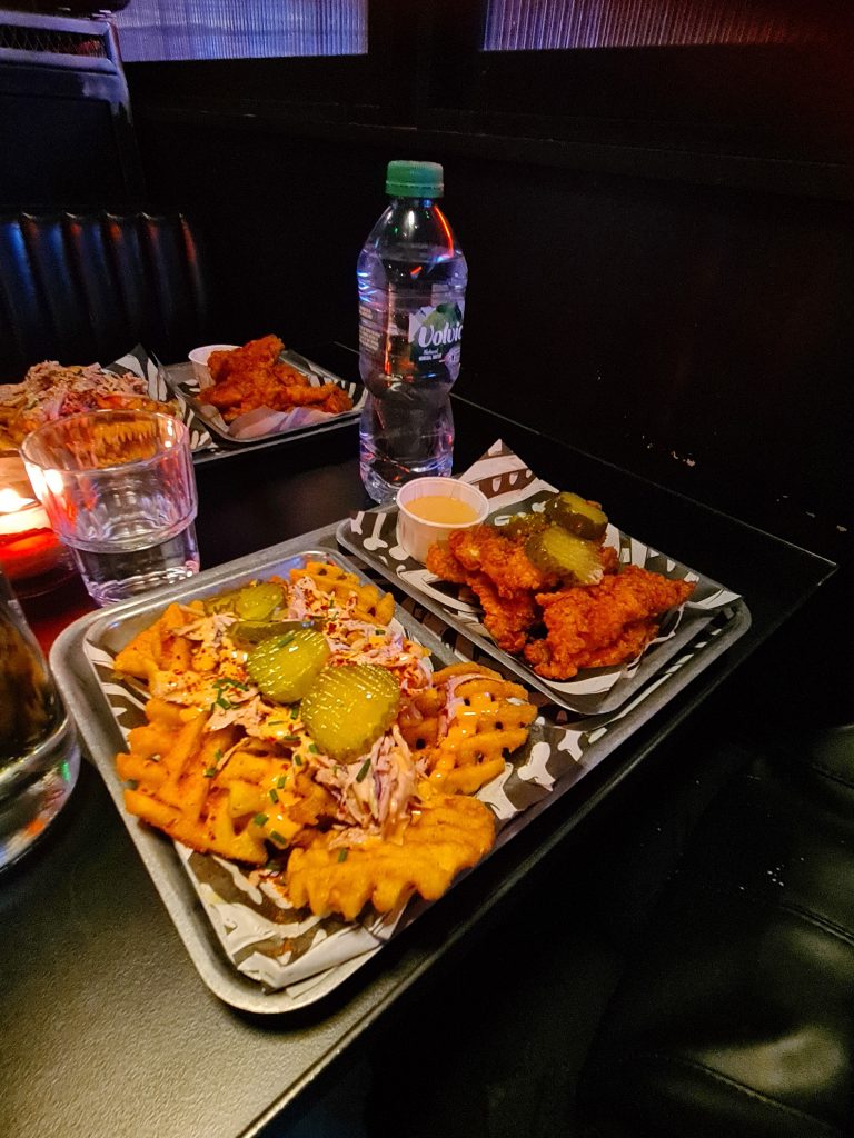 Fried chicken and chips with pickles on top
