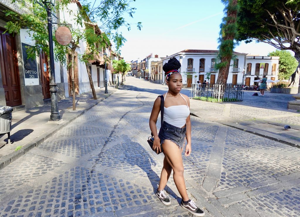 Young woman walking through streets of Teror.