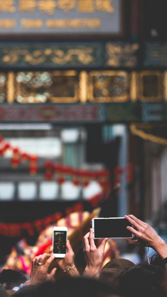 People holding a phone and a tablet