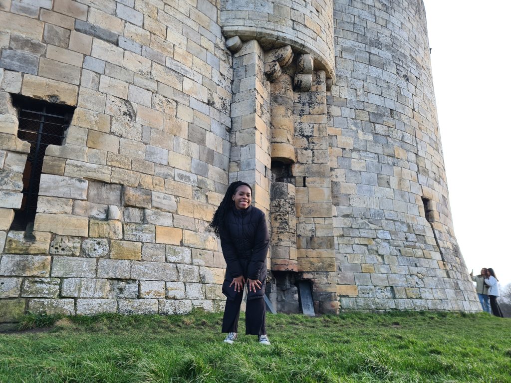 Girl smiling in front of castle