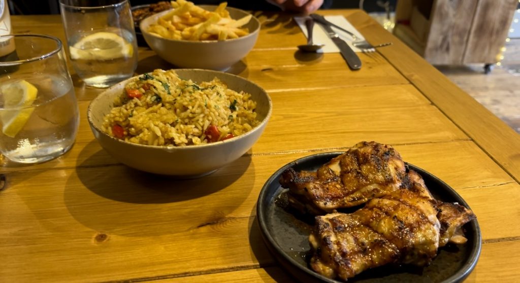 Plate of grilled chicken and bowl of rice