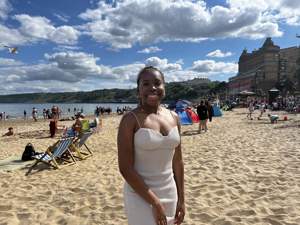 Girl posing with beach in background